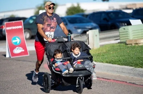 Lobo Cancer Challenge runner participant with stroller